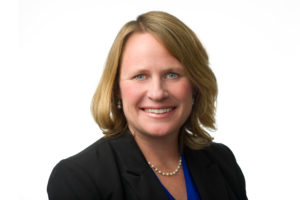 Smiling woman in a head shot wearing professional clothing. 