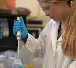 Young blonde woman in a lab.