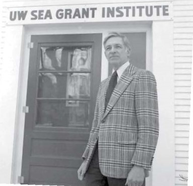 Bob Ragotzkie stands in front of the doorway to the UW Sea Grant Institute in a vintage photo likely from the early 1970s
