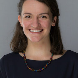 Head shot of smiling dark-haired woman.