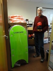 Man standing near green board