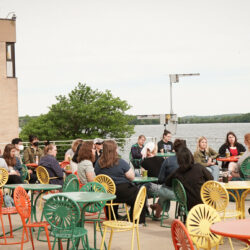 Group of people sitting outdoors in colorful chairs