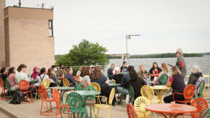 Group of people sitting outdoors in colorful chairs