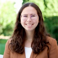 Smiling woman outdoors, wearing glasses