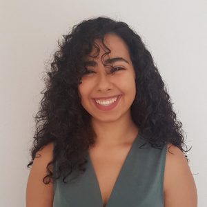 Smiling woman with long curly hair. 