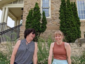 Two women sitting outdoors