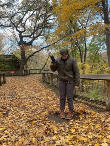 woman standing among fall leaves