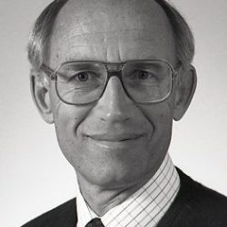 Close-up of man in a suit, tie and glasses