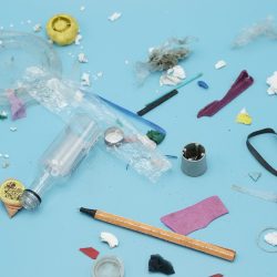 Plastic trash spread on a blue background