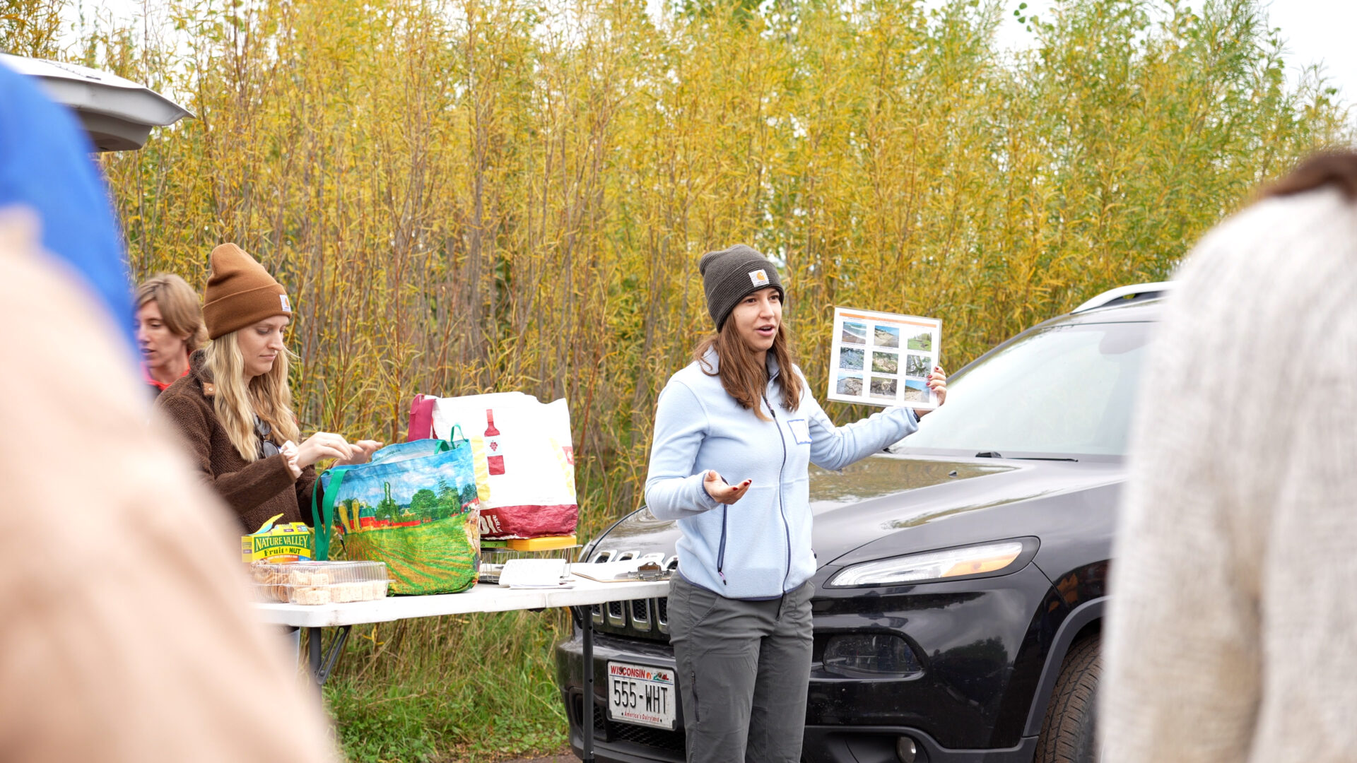 Hannah Paulson holds up the erosion checklist and explains it to participants.