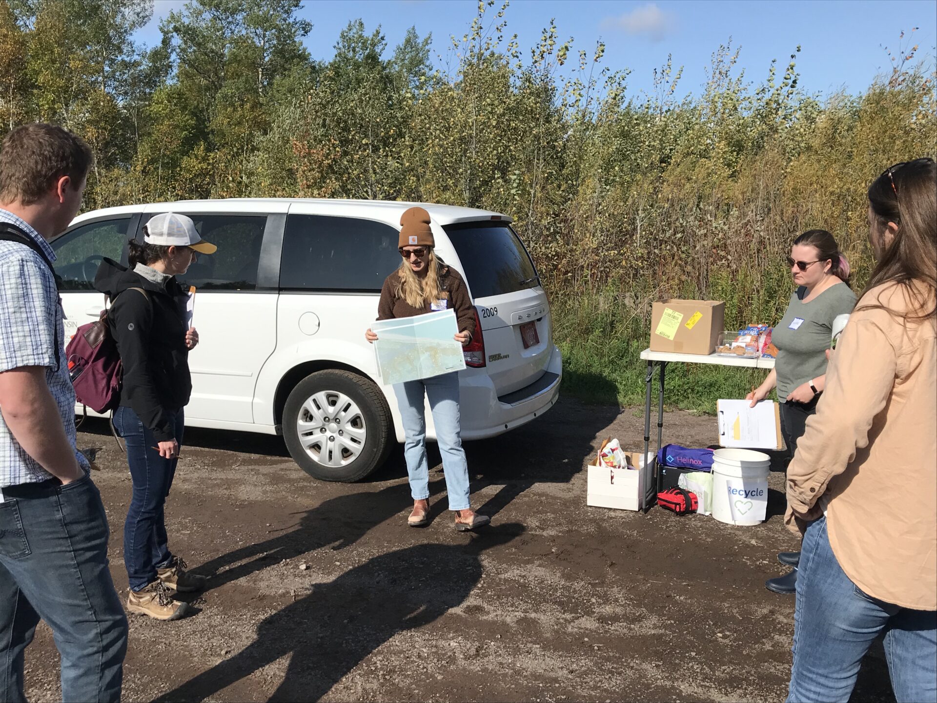 Tiedmann holds us a topographical map and discusses bluff erosion at Schafer Beach in Superior, Wisconsin.