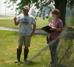 two people standing and talking outdoors