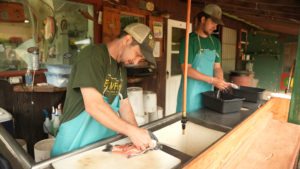 two people processing fish