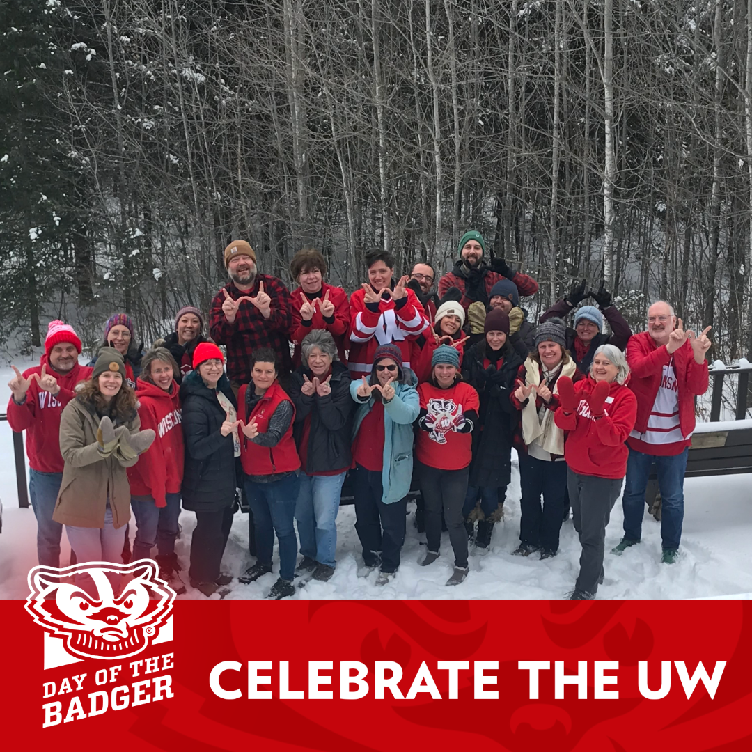 the staff of Wisconsin Sea Grant wear their best Badger gear as they stand for a photo outside in the snow