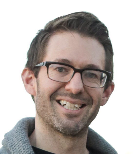 Professor Ryan Newton wears a gray sweater and glasses