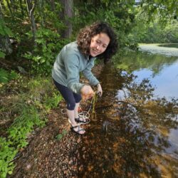 Snapshot Day participant inspects an aquatic plant.