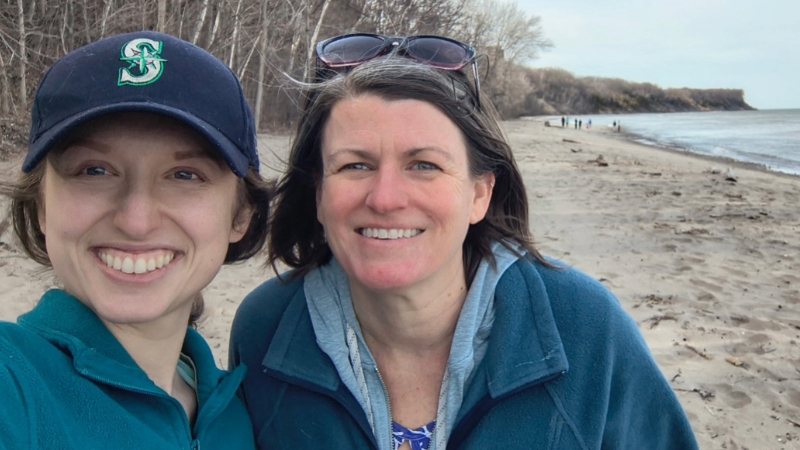 New coastal resilience specialist Carrie Malone smiles alongside Sea Grant's Deidre Peroff on a Lake Michigan beach.