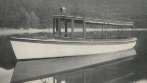 Black and white photo of a 30-foot gasoline-powered launch on calm water.