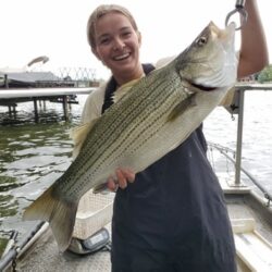 A person holding a fish.