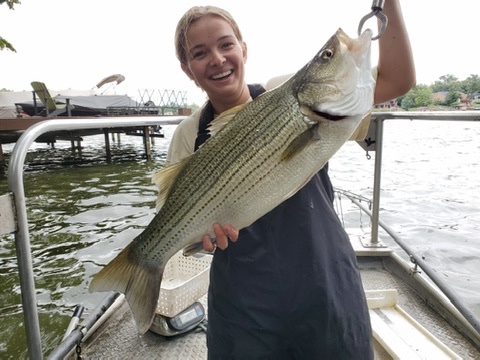 A person holding a fish.