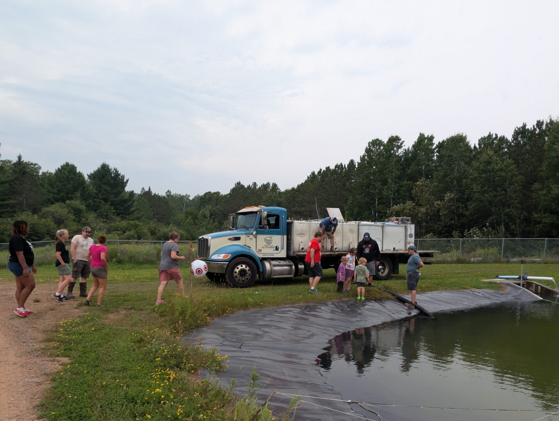 Alverno students tour an outdoor pond at Red Cliff hatchery
