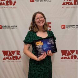 Bonnie Willison holding her two WAVE video awards.