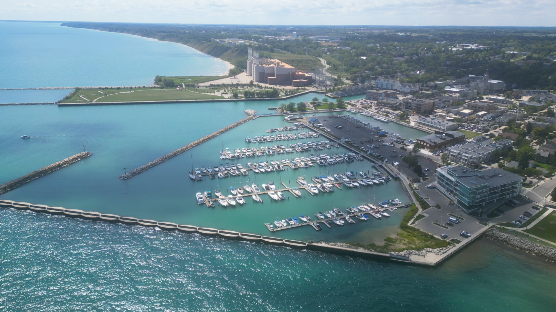 An aerial view of Port Washington Marina, showing boats floating in the light blue waters of Lake Michigan