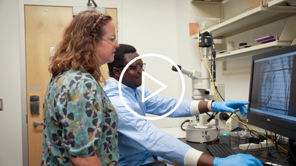 Video thumbnail showing Tisha King-Heiden and a student looking at a computer